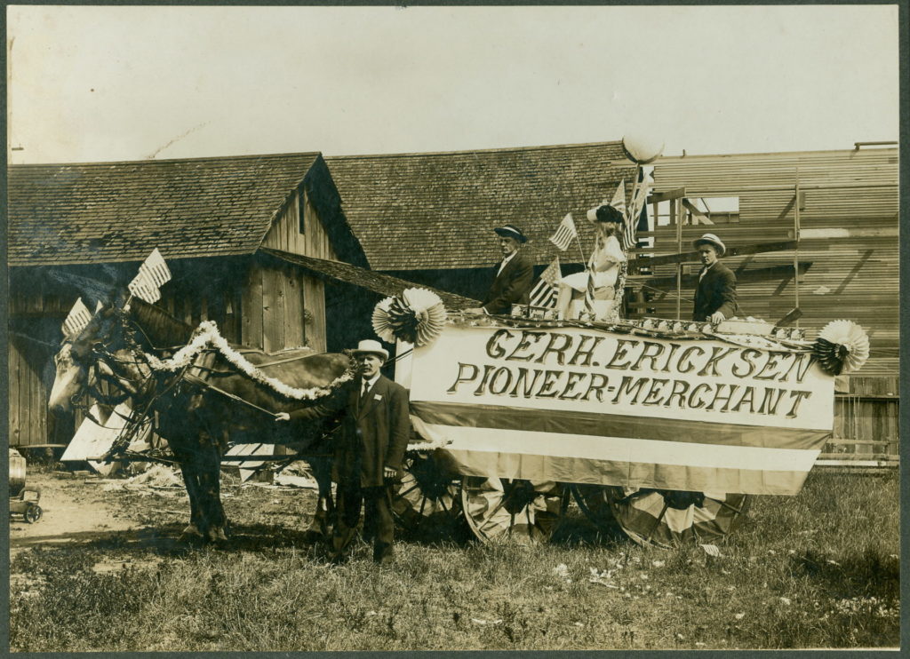 Parade float, July 4, 1908, for Gerhard Ericksen’s Mercantile, Bothell; Ericksen at far left