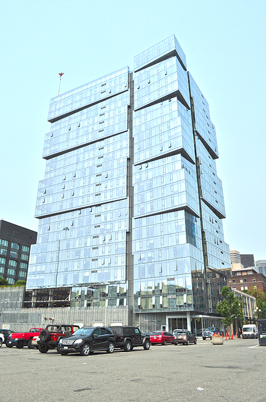 “The Wave” — the west tower of the Stadium Place complex — as seen from the parking lot of Lumen Field in August 2017